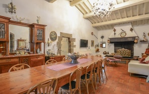 A spacious living room with a fireplace, wooden furniture, and a dining area. - Awesome home in Sesto Fiorentino with sauna (Sesto Fiorentino)