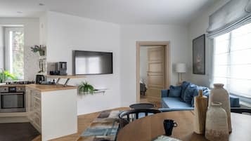 Deluxe Apartment, Balcony, Beachside | Living area | 40-inch flat-screen TV with cable channels