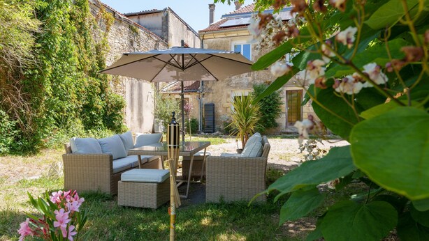 An outdoor seating area with wicker furniture and a table under a canopy. - Entire Villa: Eyrans, France – 10 Guests, 5 Bedrooms, 5 Beds, 4 Bathrooms (Eyrans)