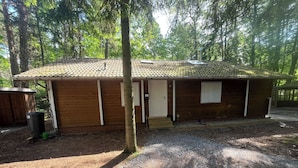 A single-story wooden building with a tiled roof, a door, and a small window. - Idyllic wooden house on the Steinhuder Meer (Neustadt am Rübenberge)