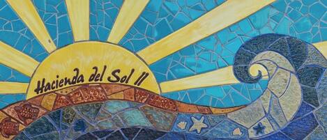 A mosaic with a sun and a wave pattern, labeled 'Hacienda del Sol II'.
