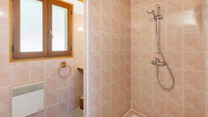 A shower with a handheld showerhead, a window with frosted glass, and a towel ring on the wall. - Guest Rooms 11 & 12 with Pool (Saint-Pompont)