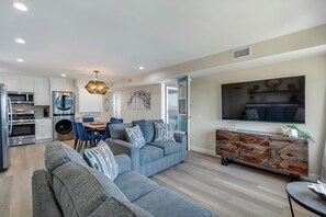 A modern living space with a kitchen, dining area, and seating area. - 3BD/3BA | Ocean Views | 1 Block to the Beach (Oceanside)