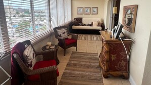 A living room with a sofa, two chairs, a wooden cabinet, and a ceiling fan. - 1200-505 Standard Plus (Siesta Key)