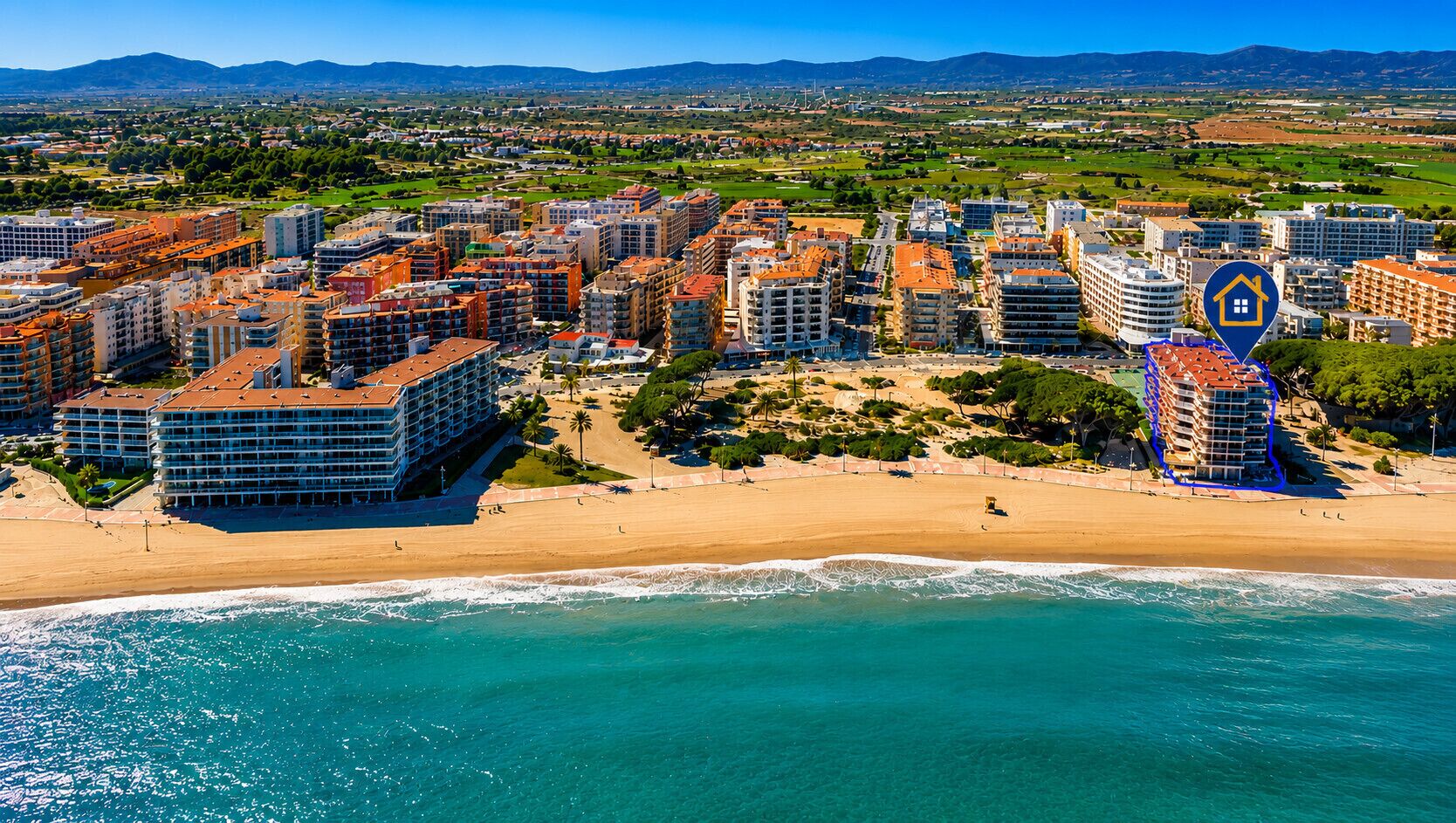 A coastal cityscape with modern buildings, a beach, and a clear view of the sea.