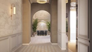 A hallway with a checkered floor, a seating area with chairs, and a decorative wall with plants. - Palazzo Giuseppe Member Of Melia Collection (Victoria)