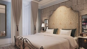 A bedroom with a large bed, a nightstand, a lamp, a mirror, and a stone-patterned wall. - Palazzo Giuseppe Member Of Melia Collection (Victoria)