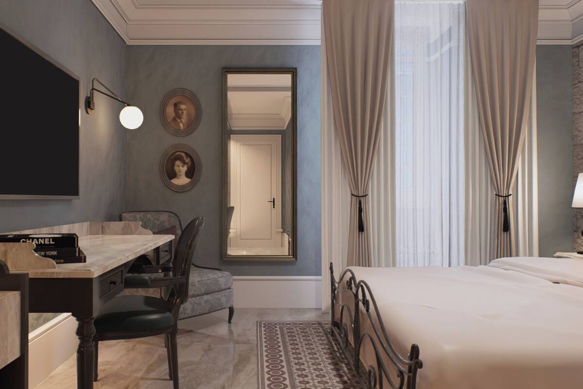 A hotel room with a bed, a desk, a chair, a mirror, and a window with curtains.