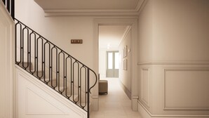 A hallway with a staircase, a door at the end, and a number sign on the wall. - Palazzo Giuseppe Member Of Melia Collection (Victoria)