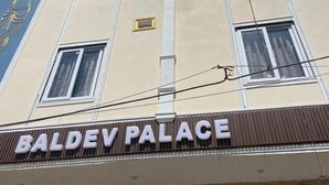 A building with a sign reading 'BALDEV PALACE' and a large arched entrance. - Hotel Baldev Palace (Vrindavan)