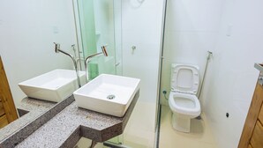 A bathroom with two sinks, a glass shower enclosure, and a toilet. - Hotel Madalena - Beiro Rio (Sao Miguel Do Guama)