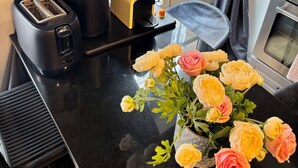 A kitchen counter with a toaster, a coffee maker, and a vase of flowers. - Odéon Saint Germain - Central Flat Aldaro (Paris)