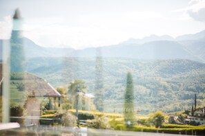 A view of a mountainous landscape with a house and trees.