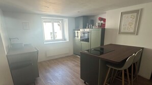 A compact kitchen with a dining area, a window, and a refrigerator. - Spacious, newly renovated townhouse (Toul)