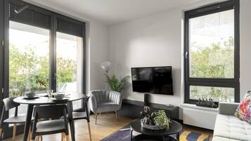Apartamento luxo, cozinha americana, vista para o pátio | Área de estar | TV de tela plana 40 polegadas com canais a cabo