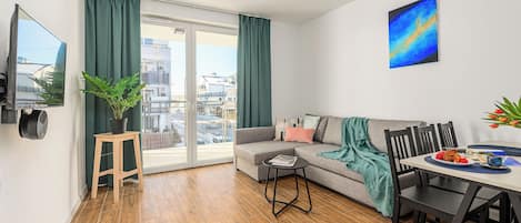 Family Apartment, Balcony, Courtyard View | Living area | Flat-screen TV