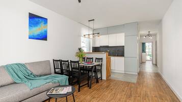 Family Apartment, Balcony, Courtyard View | Living area | Flat-screen TV
