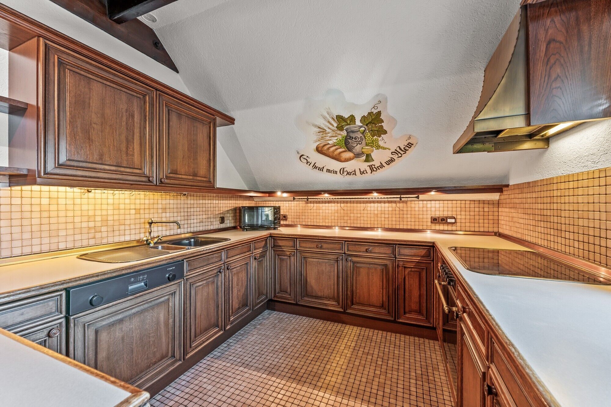 A kitchen with wooden cabinets, a tiled backsplash, a microwave, and a sink.