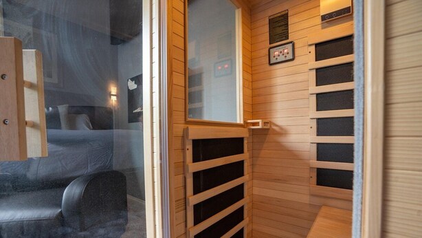 A sauna room with a wooden interior, a glass door, and a control panel on the wall. - Sauna, Free Dollywood & More, Views! - (Gatlinburg)