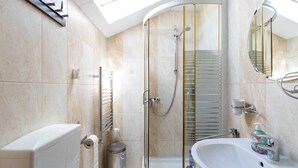 A modern bathroom with a glass shower enclosure, a toilet, a bidet, and a sink with a mirror. - FarawayHomes Aparthotel Vienna Airport #8 (Bruck an der Leitha)