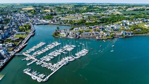 An aerial view of a coastal town with a marina filled with boats, surrounded by residential and commercial buildings. - Two Pod Glamping Retreat in Kinsale, Sea Views (Kinsale)