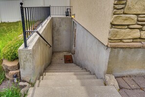 A concrete staircase with a metal railing, leading to a door with a light fixture above it. - All-season Base in West Valley City, Pets Welcome! (West Valley City)
