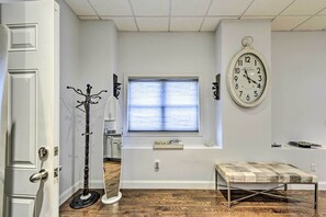 A room with a large window, a wall clock, a coat rack, and a bench. - Pet-friendly Apartment, 6 Miles to Downtown (Revere)