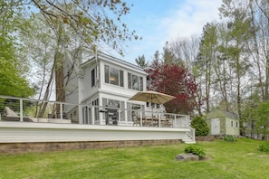 A two-story house with a balcony, a small shed, and a lawn. - Kayaks, Paddleboat! Lakefront Retreat in Barnstead (Center Barnstead)