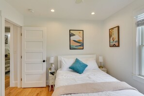 A bedroom with a bed, bedside tables, a door, and a window. - Walkable + Convenient! 1st-floor Apt in Middletown (Middletown)