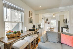 A modern kitchen with a dining area, a sofa, and a window with blinds. - Walkable + Convenient! 1st-floor Apt in Middletown (Middletown)
