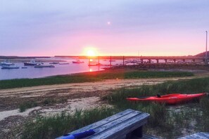 A sunset view with boats, a wooden dock, and a red kayak. - Waterfront Studio w/ Dock & Beach Access in Truro! (Truro)