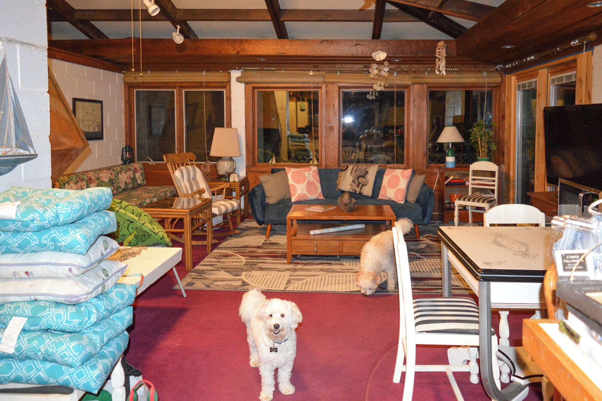 A cozy living room with a sofa, chairs, a coffee table, and a TV.