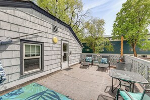 A patio with outdoor furniture, a window, and a door. - Walkable Family Home in the Heart of Kalispell (Kalispell)