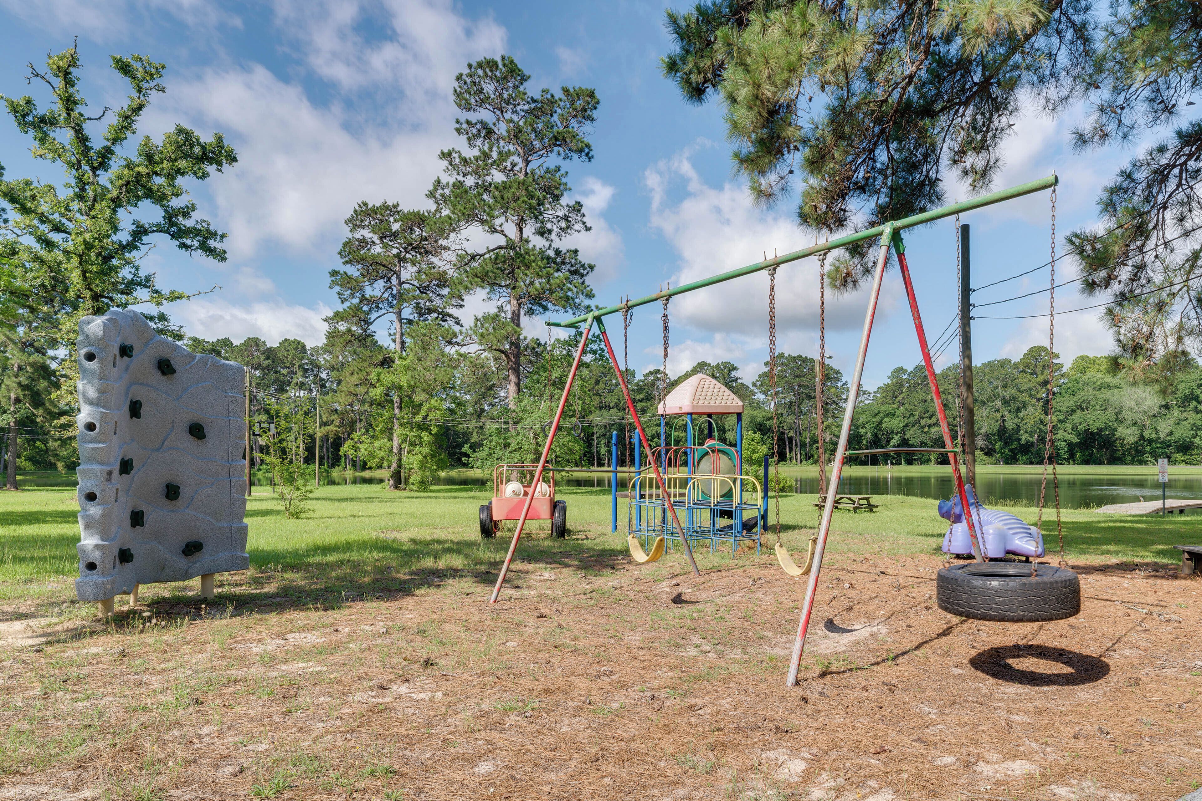 A playground with swings, a tire swing, and a climbing structure.