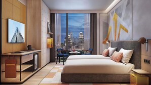 A modern hotel room with a large bed, a desk, a chair, a small table, and a city view through large windows. - Ibis Bangkok Siam Ratchathewi (Bangkok)