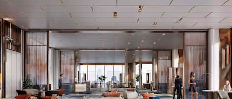 Un hall d’entrée spacieux, doté d’espaces de détente, d’une table basse centrale et offrant une vue sur le paysage urbain grâce à de grandes fenêtres.