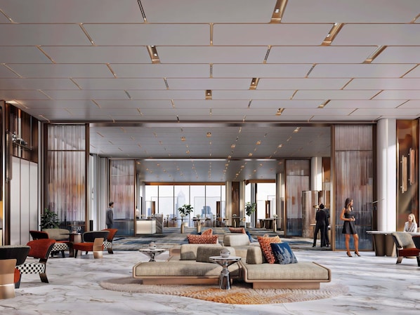 A spacious lobby with seating areas, a central coffee table, and a view of the cityscape through large windows. - Ibis Bangkok Siam Ratchathewi (Bangkok)