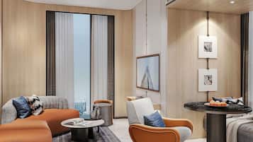 A modern hotel room with a sofa, armchair, coffee table, and a small dining table.