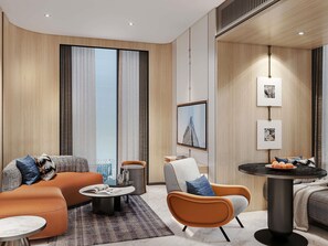 A modern hotel room with a sofa, armchair, coffee table, and a small dining table. - Mercure Bangkok Siam Ratchathewi (Bangkok)