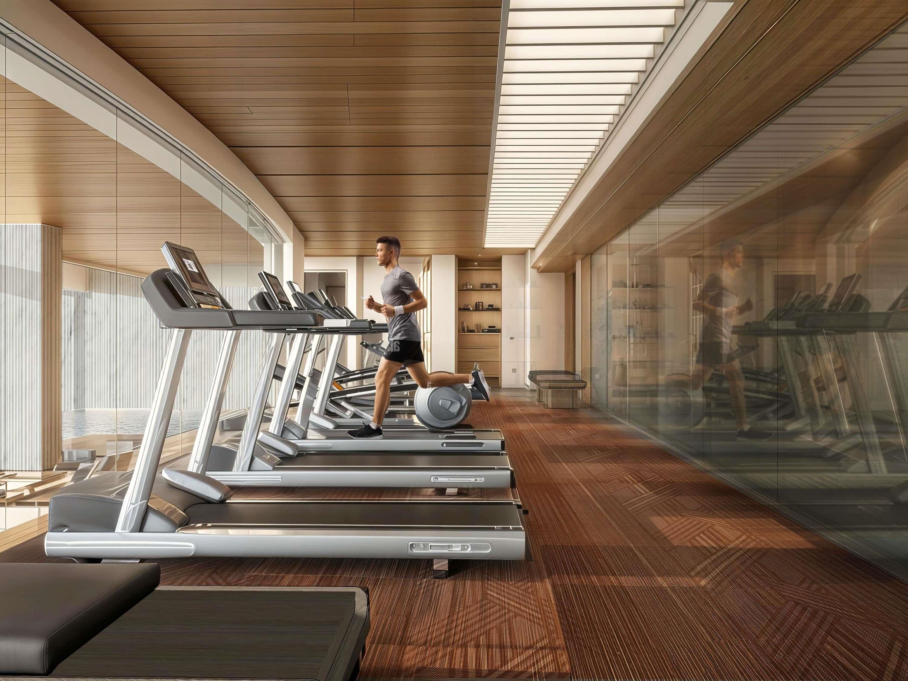 A modern gym with treadmills, a weight bench, and a mirrored wall.