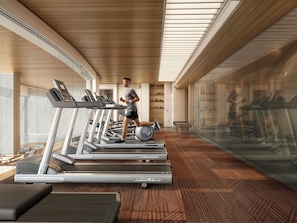 A modern gym with treadmills, a weight bench, and a mirrored wall. - Mercure Bangkok Siam Ratchathewi (Bangkok)