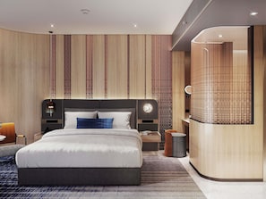 A modern hotel room with a large bed, a nightstand, a bedside table, a wall-mounted clock, and a built-in vanity with a mirror. - Mercure Bangkok Siam Ratchathewi (Bangkok)