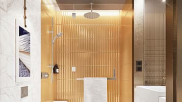 Un baño moderno con ducha, inodoro y lavamanos.
