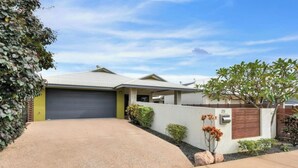 A residential house with a garage, a driveway, and a small garden with rocks and plants. - Zen Courtyard Garden - Patio - Garage (Darwin)