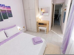 A bedroom with a bed, a desk, a wardrobe, and a mirror. - Marilia Guesthouse-seaside Garden View Stay Evia (Mantoudi-Limni-Agia Anna)