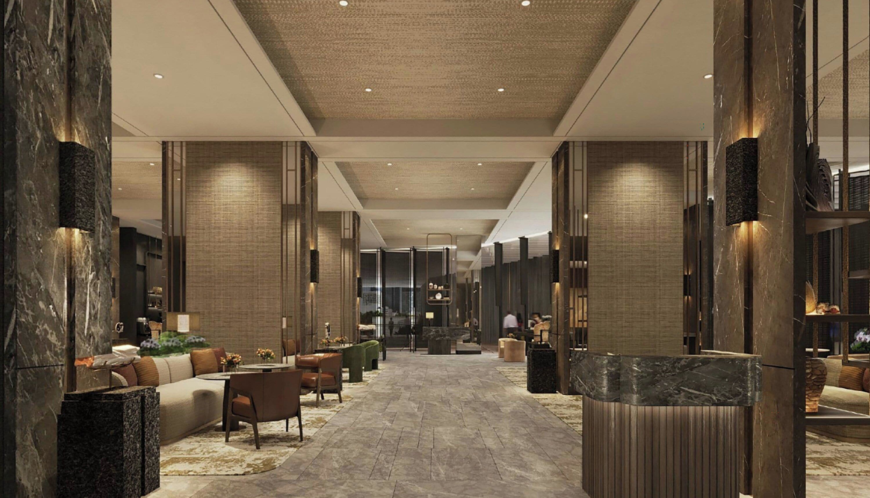A modern lobby with marble columns, a central seating area, and a reception desk.