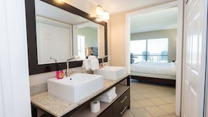 A modern bathroom with two sinks, a large mirror, and a view of a balcony. - Direct Beachfront 3br 3 Pools & 3 Jacuzzis 3 Bedroom Apts (South Padre Island)