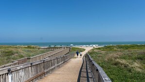 A wooden boardwalk leading to a beach with a clear view of the ocean. - Family Condo Pool, Jacuzzi & Bbq Walk To Beach 2 Bedroom Apts (South Padre Island)