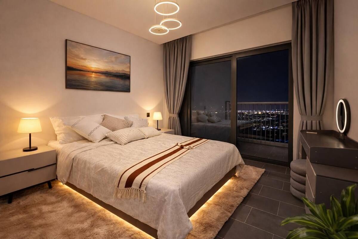 A modern bedroom with a large bed, bedside lamps, a city view, and a nightstand.