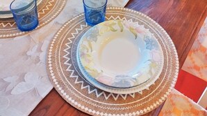 A dining table set with plates, glasses, and a teapot. - Tuscany natural stone house with fireplace & panorama - quiet near Vinci, close to Florence (Mezzana)
